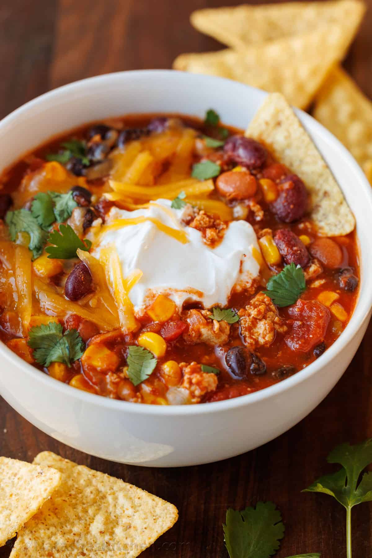 Bowl of the best turkey chili recipe with tortilla chips on the side