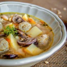 A white bowl of turkey meatball soup