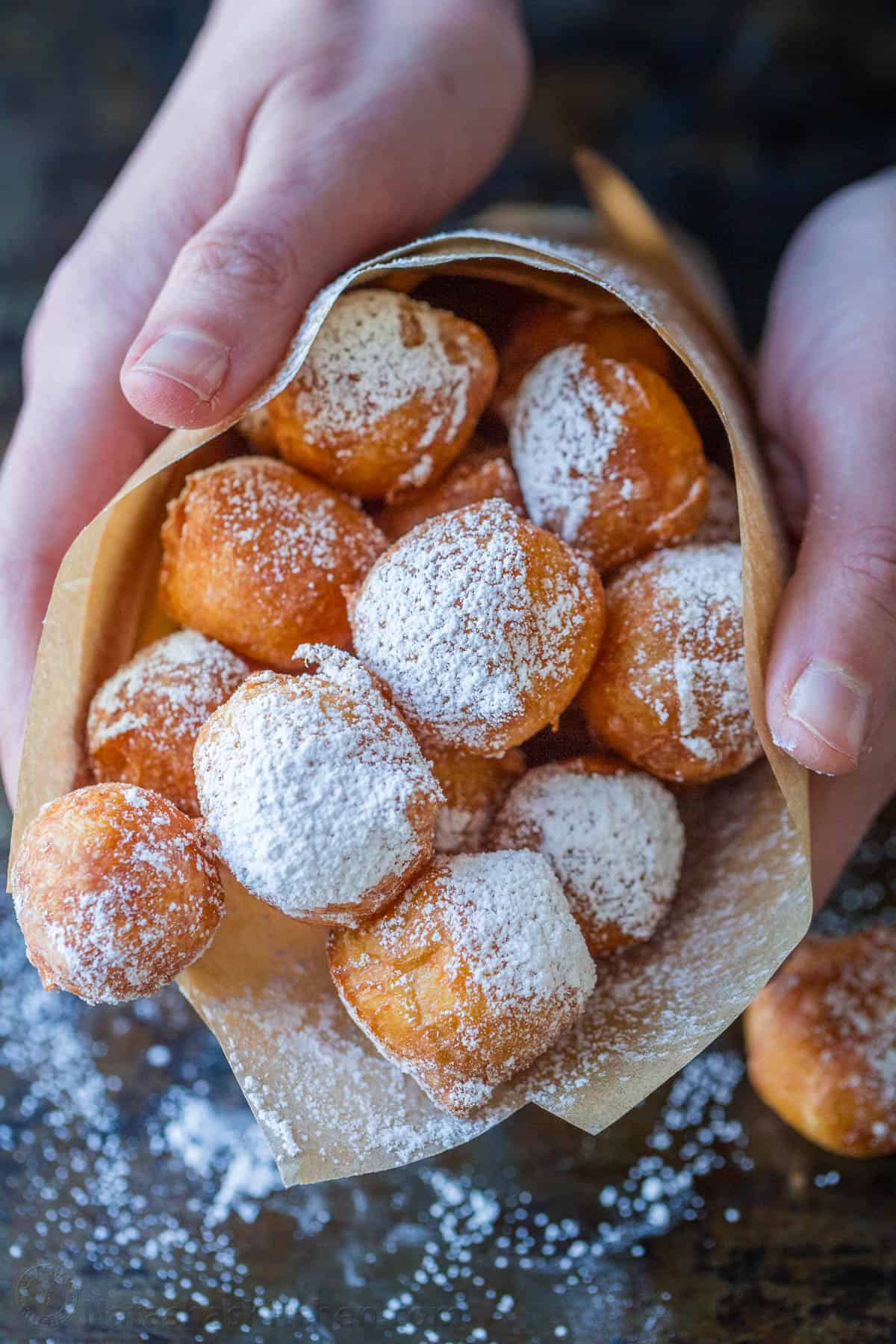Zeppole donuts are rolled in sugar with a fluffy, melt-in-your-mouth center. These Italian donut holes are simple to make and always disappear fast. Zeppole donuts with powdered sugar