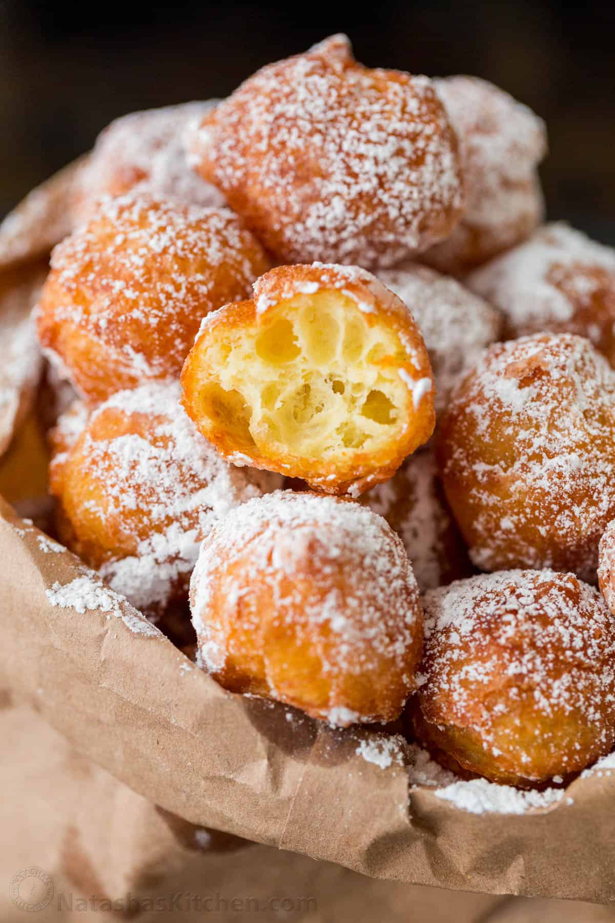 Zeppole donuts are rolled in sugar with a fluffy, melt-in-your-mouth center. These Italian donut holes are simple to make and always disappear fast. Powder sugar dusted donuts in bag